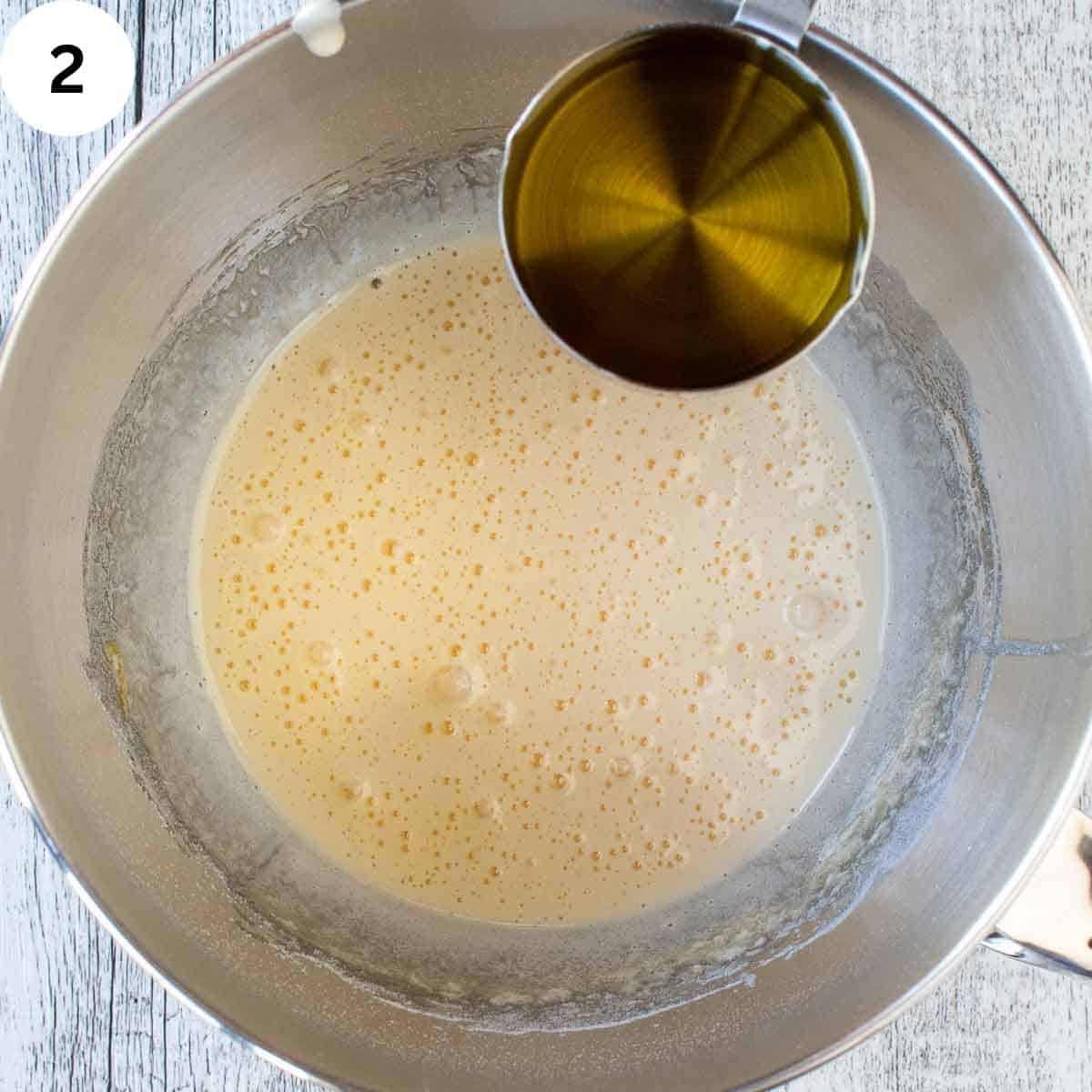 Adding oil to frothy batter.