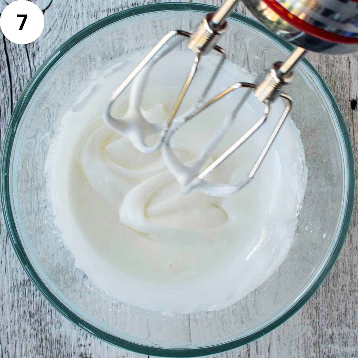 White icing beaten with electric mixer.