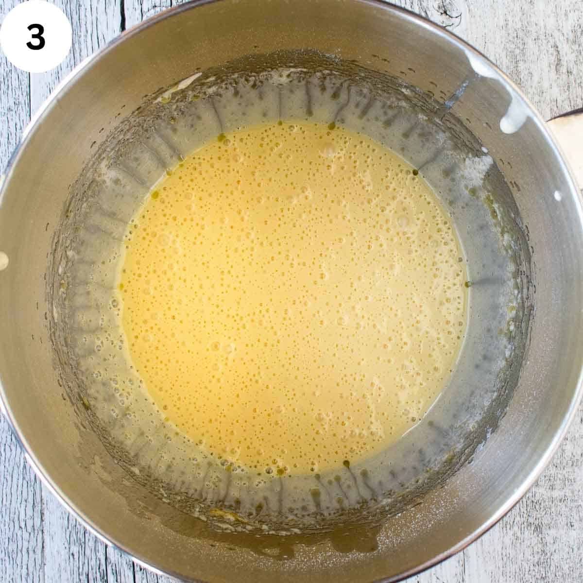 Yellow frothy liquid in a stainless steel bowl.