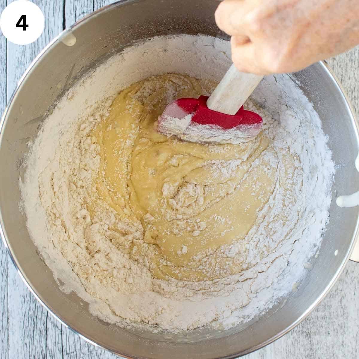 Stirring flour into batter.